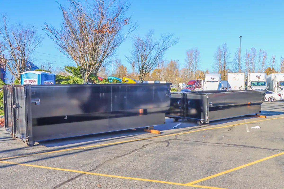 Professional dumpster rental service with roll-off container on residential driveway in Rosamond